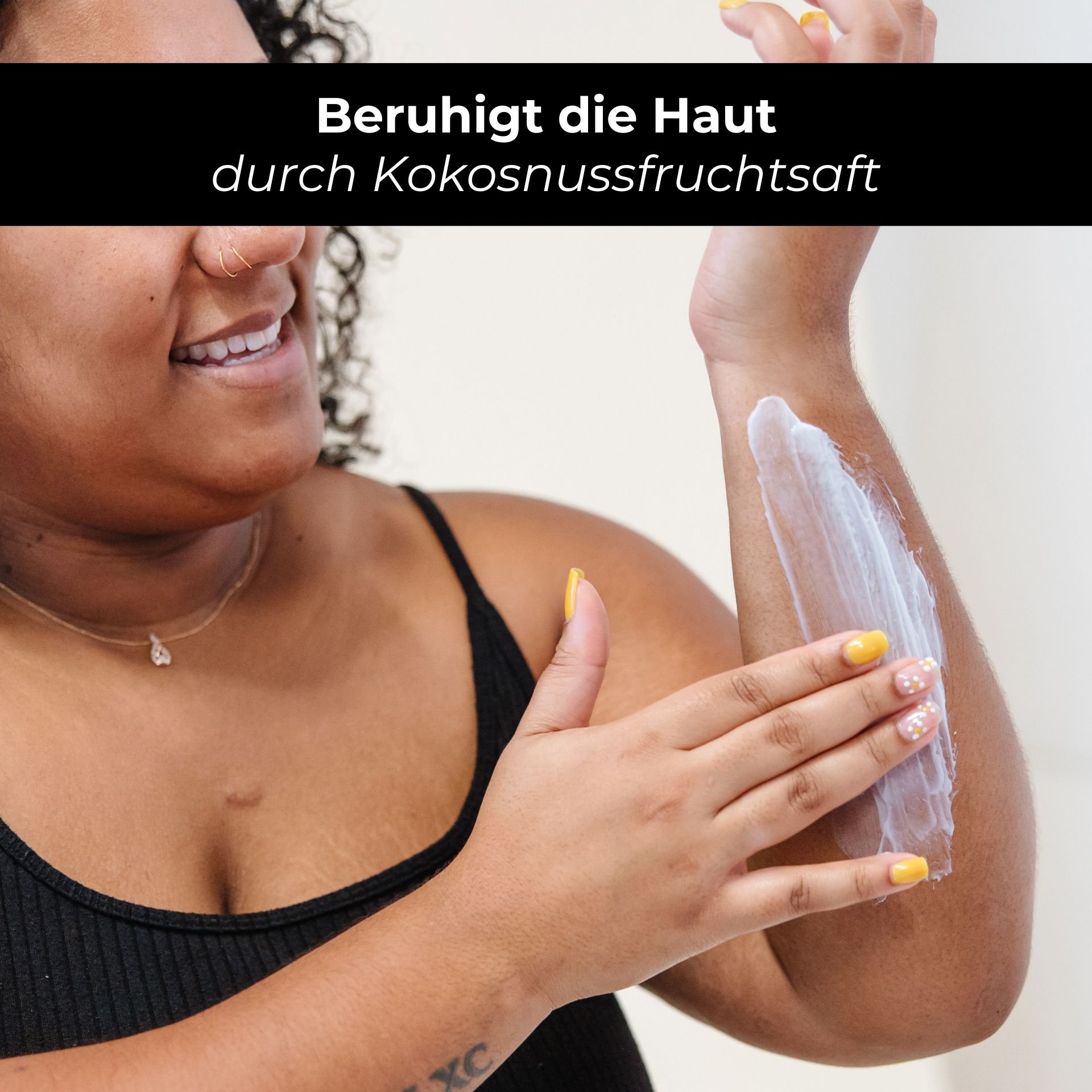 Woman with curly hair applying RAU Eternal Moist Body Lotion to her arm, emphasizing the soothing effect of coconut fruit juice.